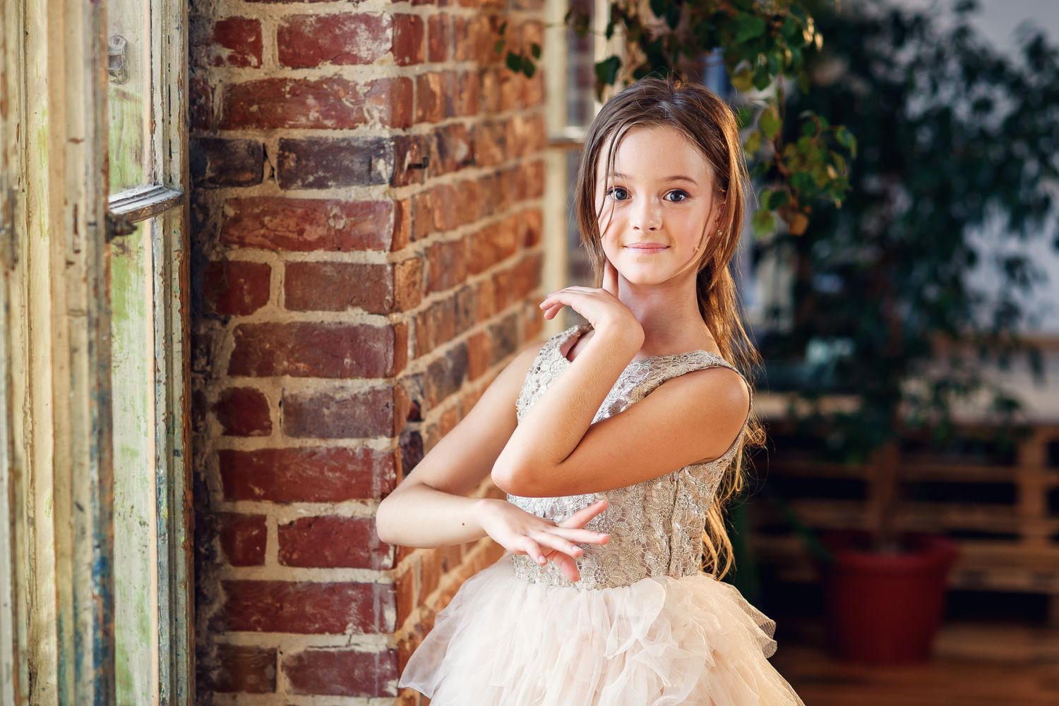 Young ballerina in tutu and pointe ballet shoes practicing dance moves in the dancing hall. Young girl in ballet dress at dance school.